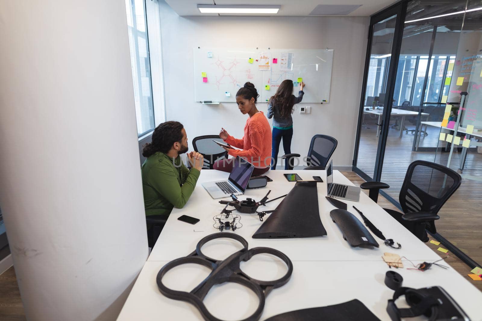 Diverse group of creative colleagues discussing work and brainstorming at meeting. modern office of a creative design business.