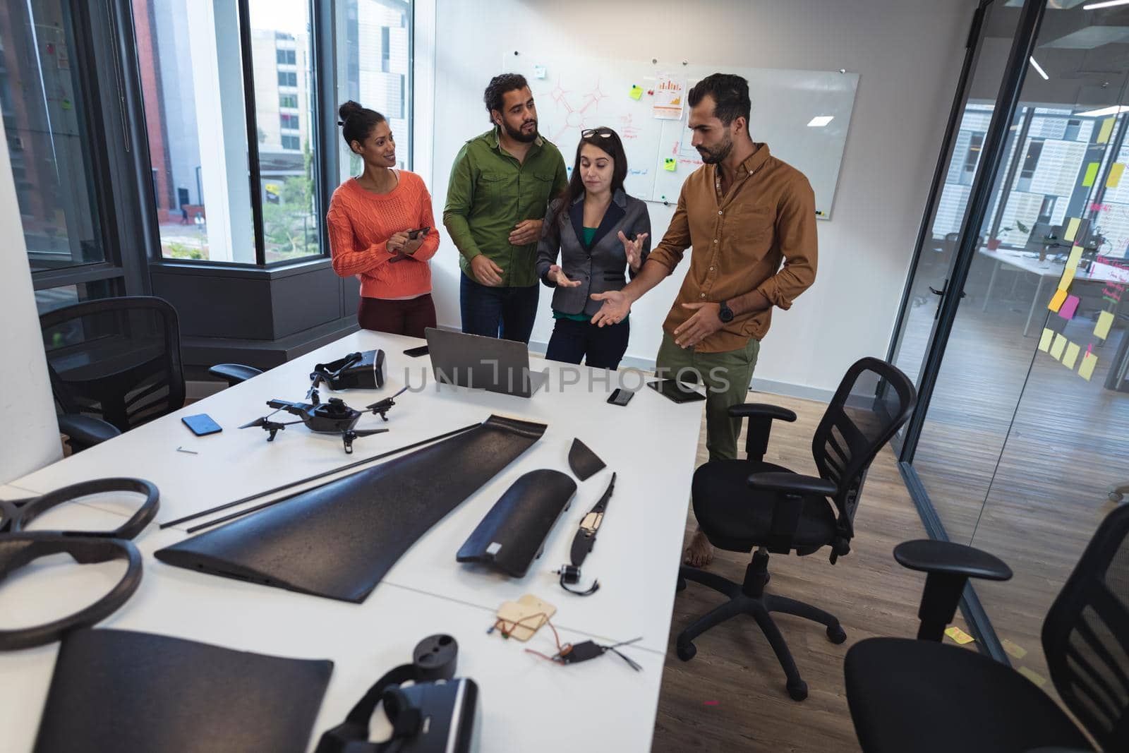 Diverse group of creative colleagues discussing work and brainstorming at meeting. modern office of a creative design business.