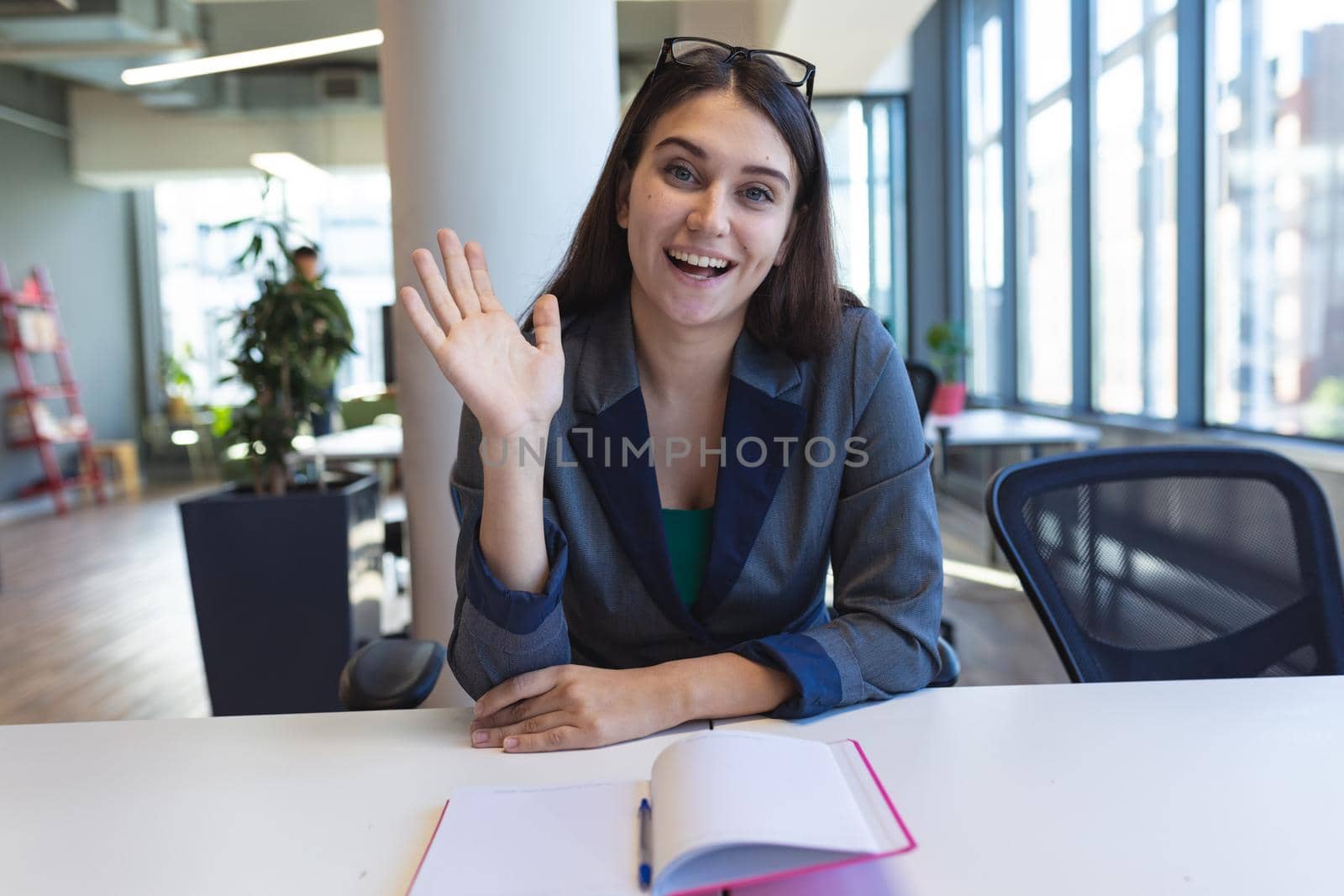 Portrait of caucasian female creative worker sitting at desk looking at camera by Wavebreakmedia