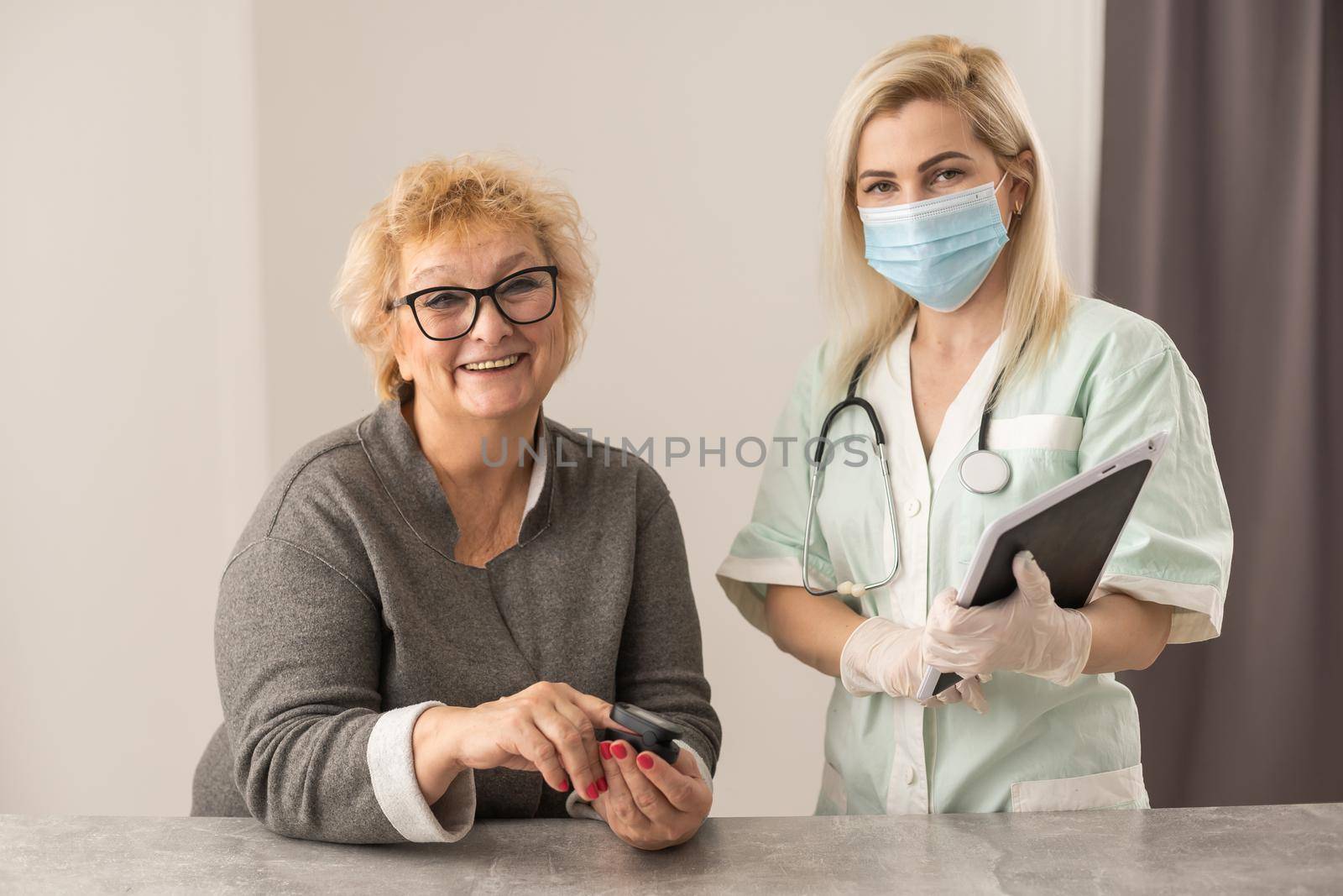 doctor talk with old female patient about disease symptom, doctor use fingertip pulse oximeter with old patient, elderly health check up and health screening, medical technology.