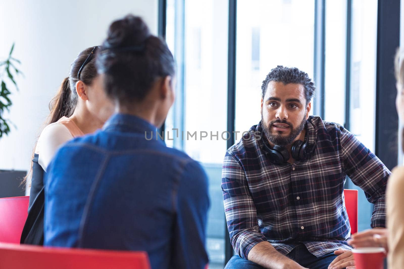 Diverse group of creative colleagues talking at casual meeting. modern office of a creative design business.