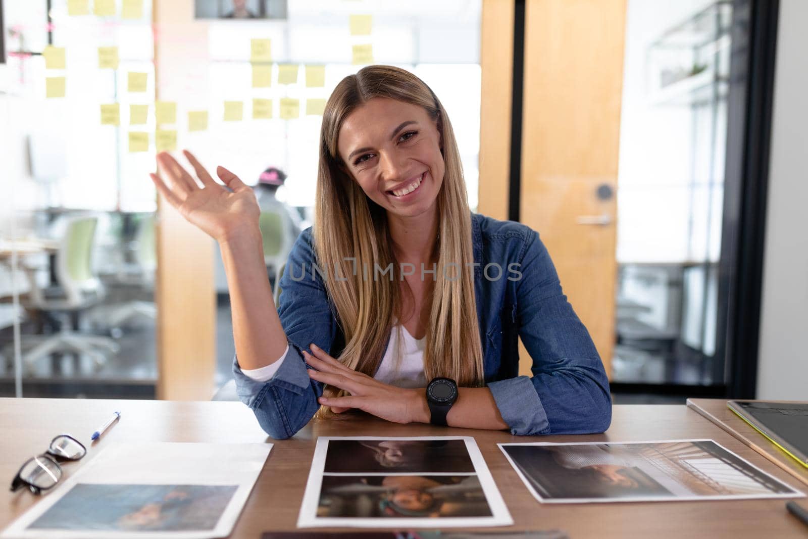 Happy caucasian businesswoman sitting at desk having video call conversation in meeting room. independent creative business