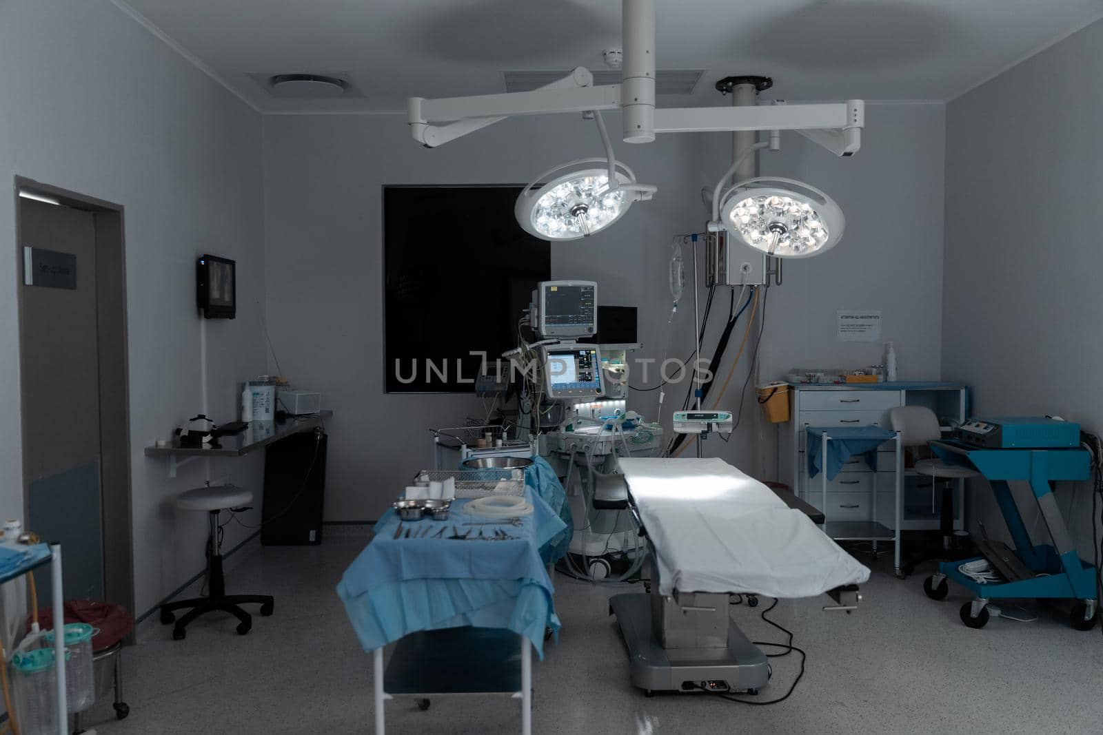 Surgical instruments, operating table, lights and equipment in modern hospital operating theatre. medicine, health and healthcare services.