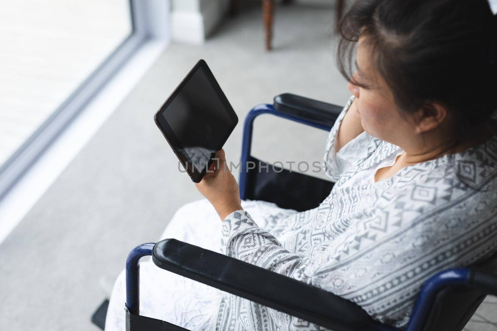 Happy senior asian woman at home using tablet. senior lifestyle, spending time at home with family.