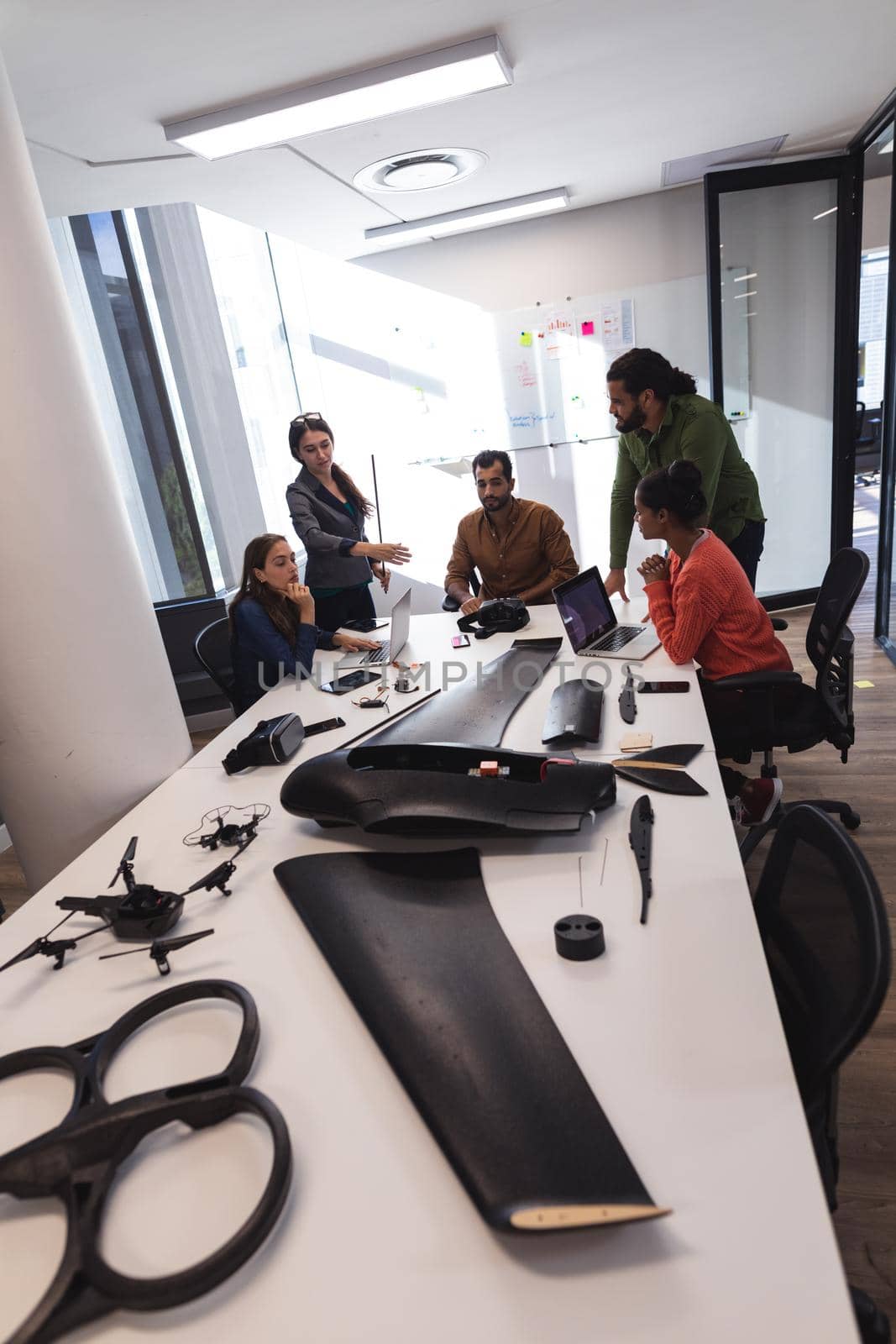 Diverse group of creative colleagues discussing work and brainstorming at meeting. modern office of a creative design business.