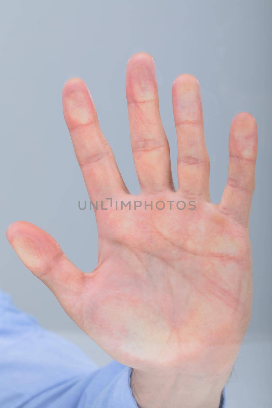 Close up of caucasian businessman touching virtual interface, isolated on grey background. business technology, communication and growth concept.