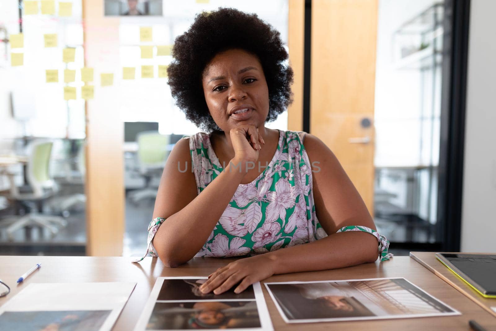 African american businesswoman sitting at desk having video call conversation in meeting room. independent creative business