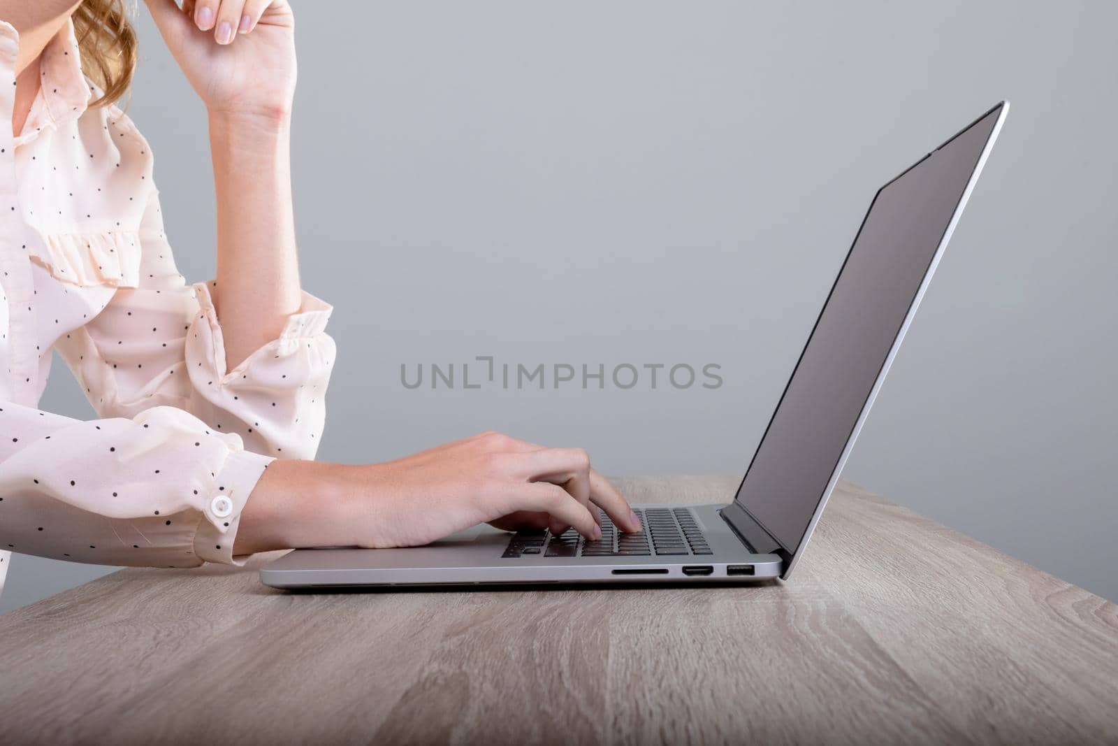 Midsection of caucasian businesswoman using laptop, isolated on grey background. business, technology, communication and growth concept.