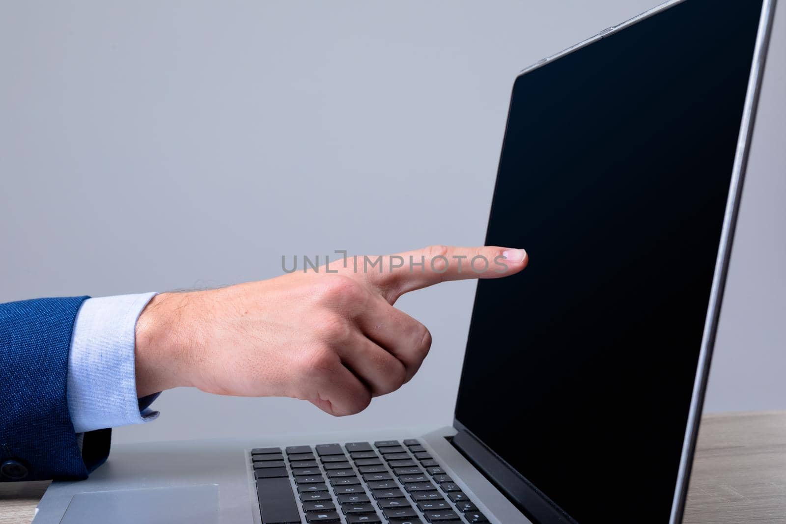 Midsection of caucasian businessman using laptop, isolated on grey background. business technology, communication and growth concept.