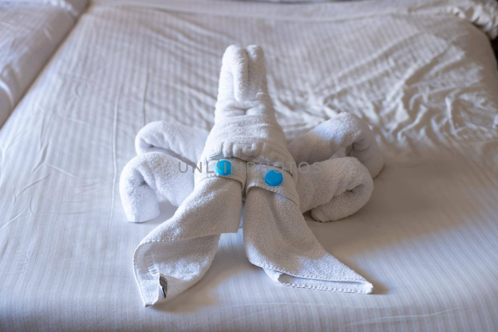 Scorpion figurine made from towels on a bed in a hotel room