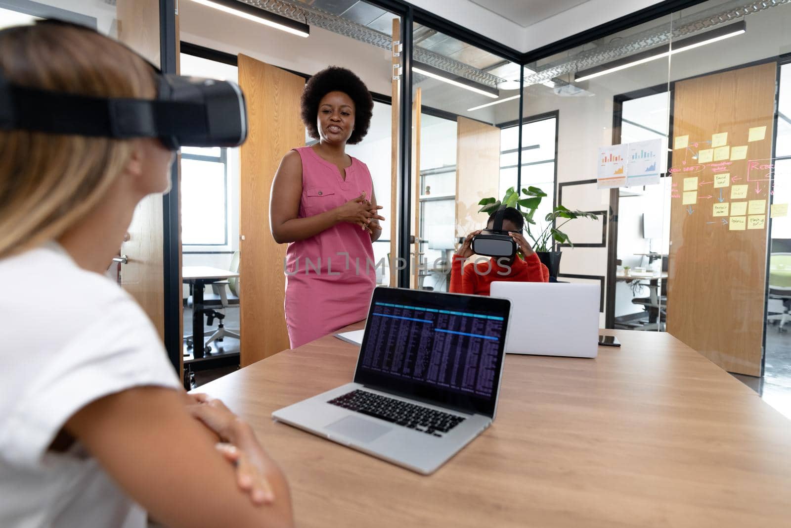Diverse group of business colleagues using vr headset in meeting room by Wavebreakmedia