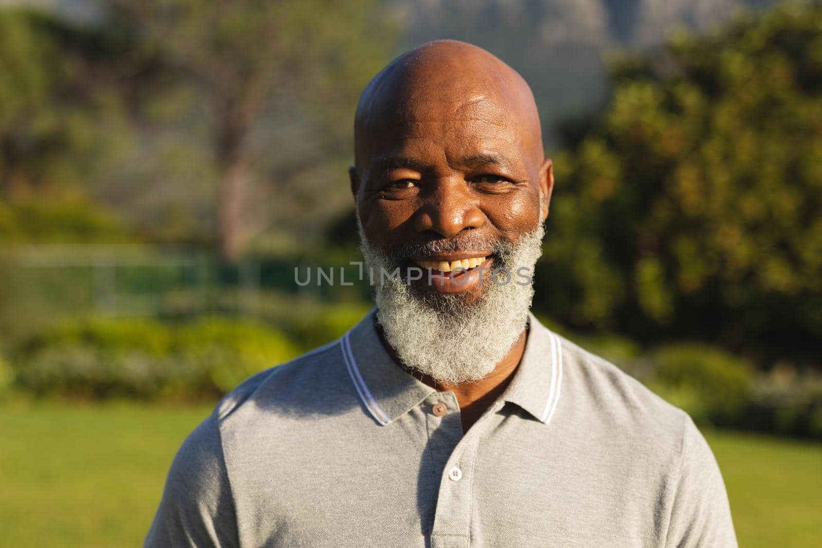 Portrait of smiling senior african american man in stunning countryside by Wavebreakmedia