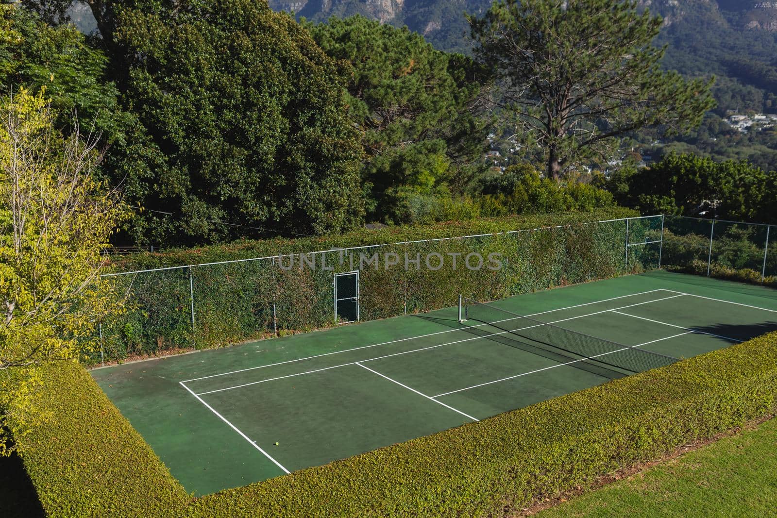 General view of tennis court in stunning countryside on sunny day by Wavebreakmedia