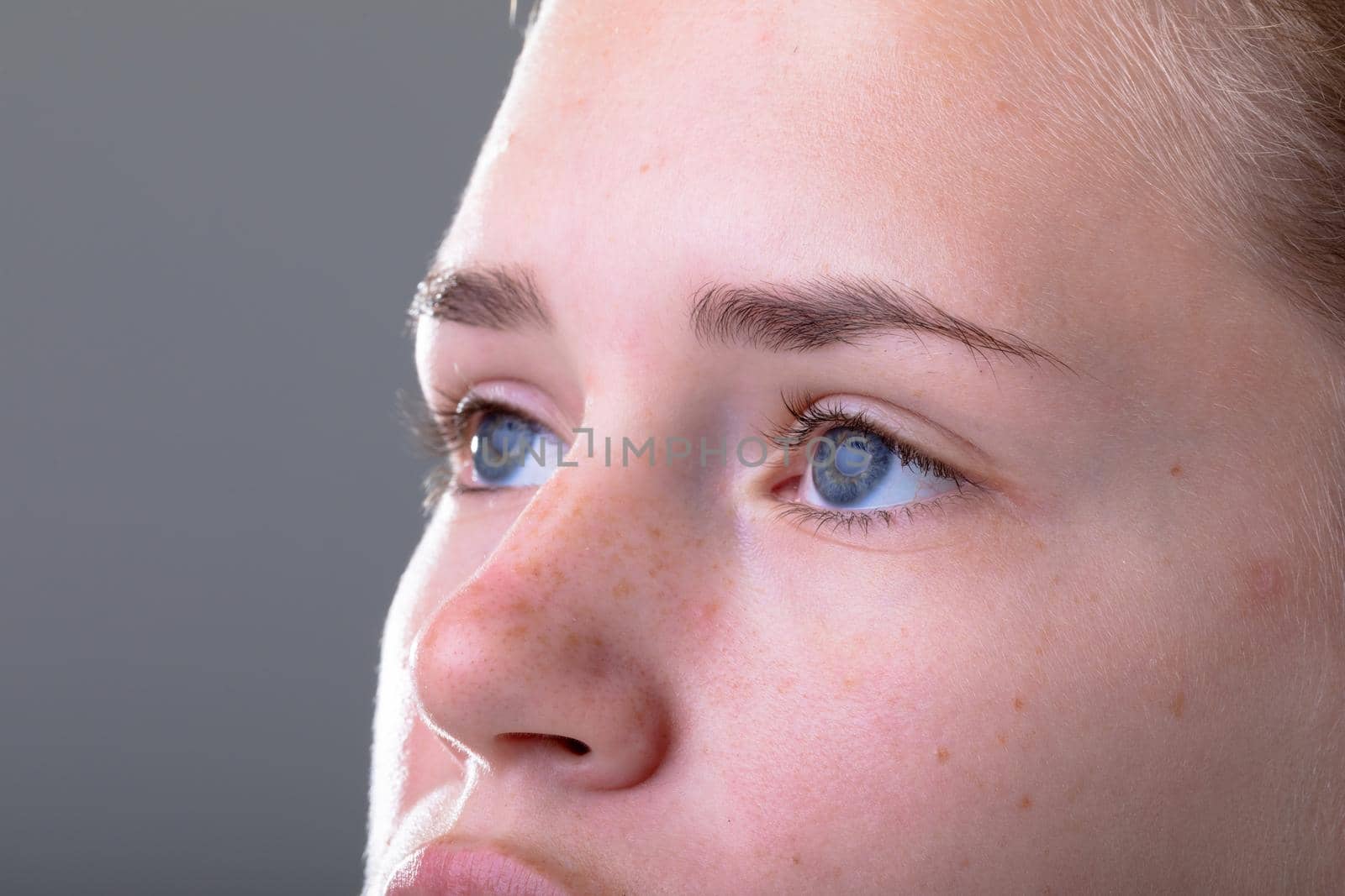 Close up of blue eyes of caucasian businesswoman, isolated on grey background. business technology, communication and growth concept digitally generated composite image.