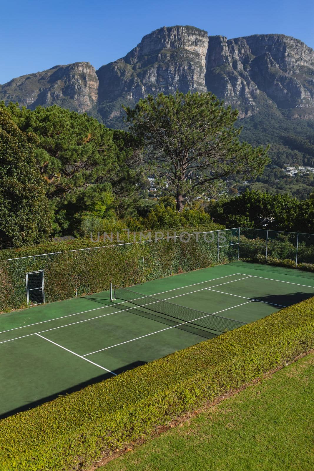 General view of tennis court in stunning countryside on sunny day by Wavebreakmedia