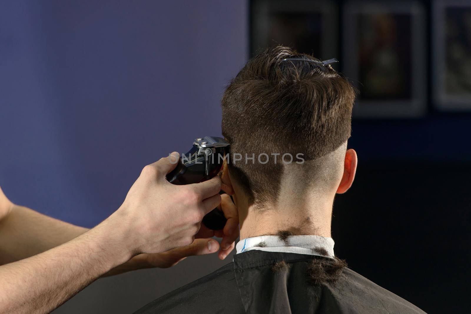 Close up of hair clipper. Person getting a haircut.