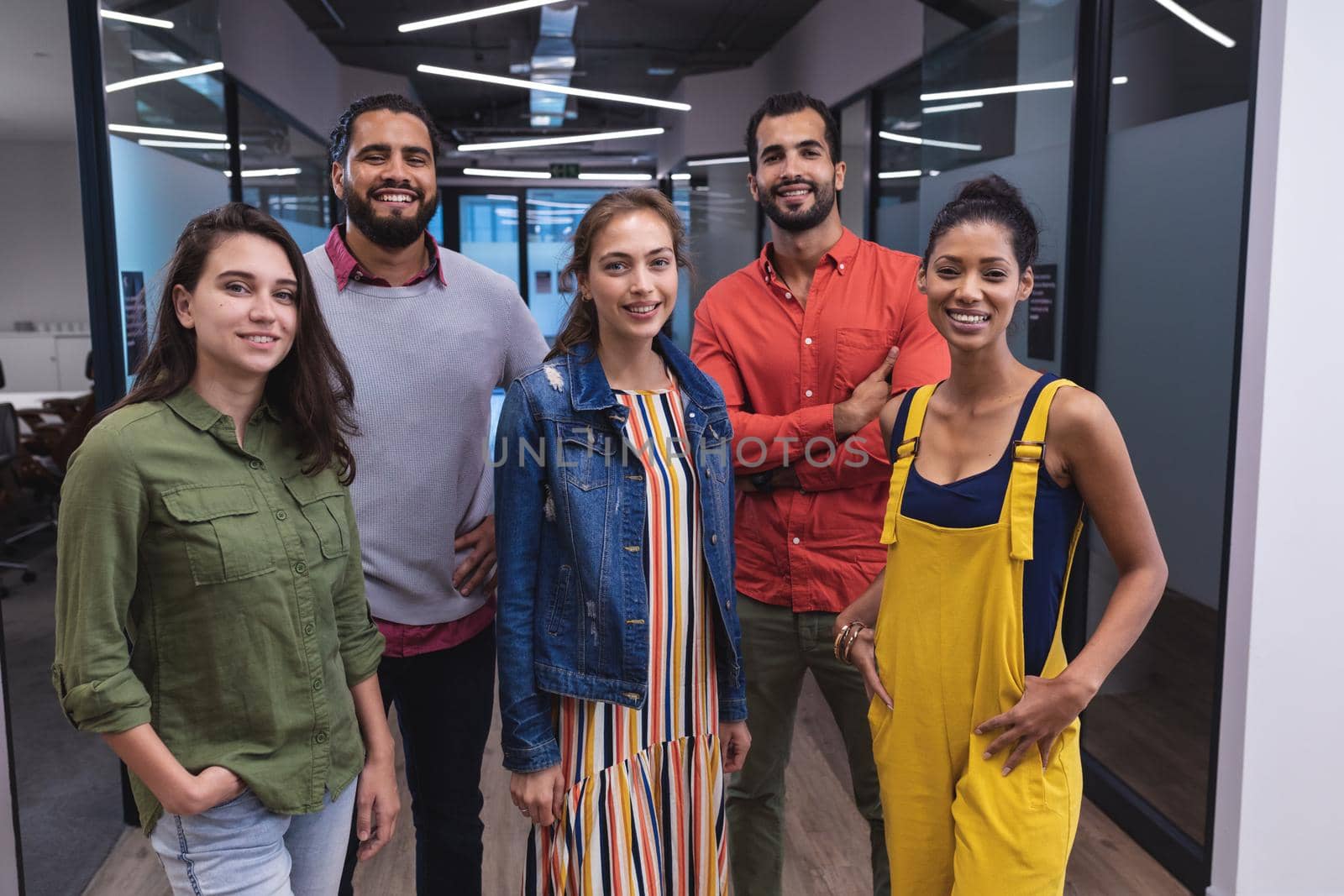 Portrait of diverse group of creative colleagues looking at camera and smiling by Wavebreakmedia