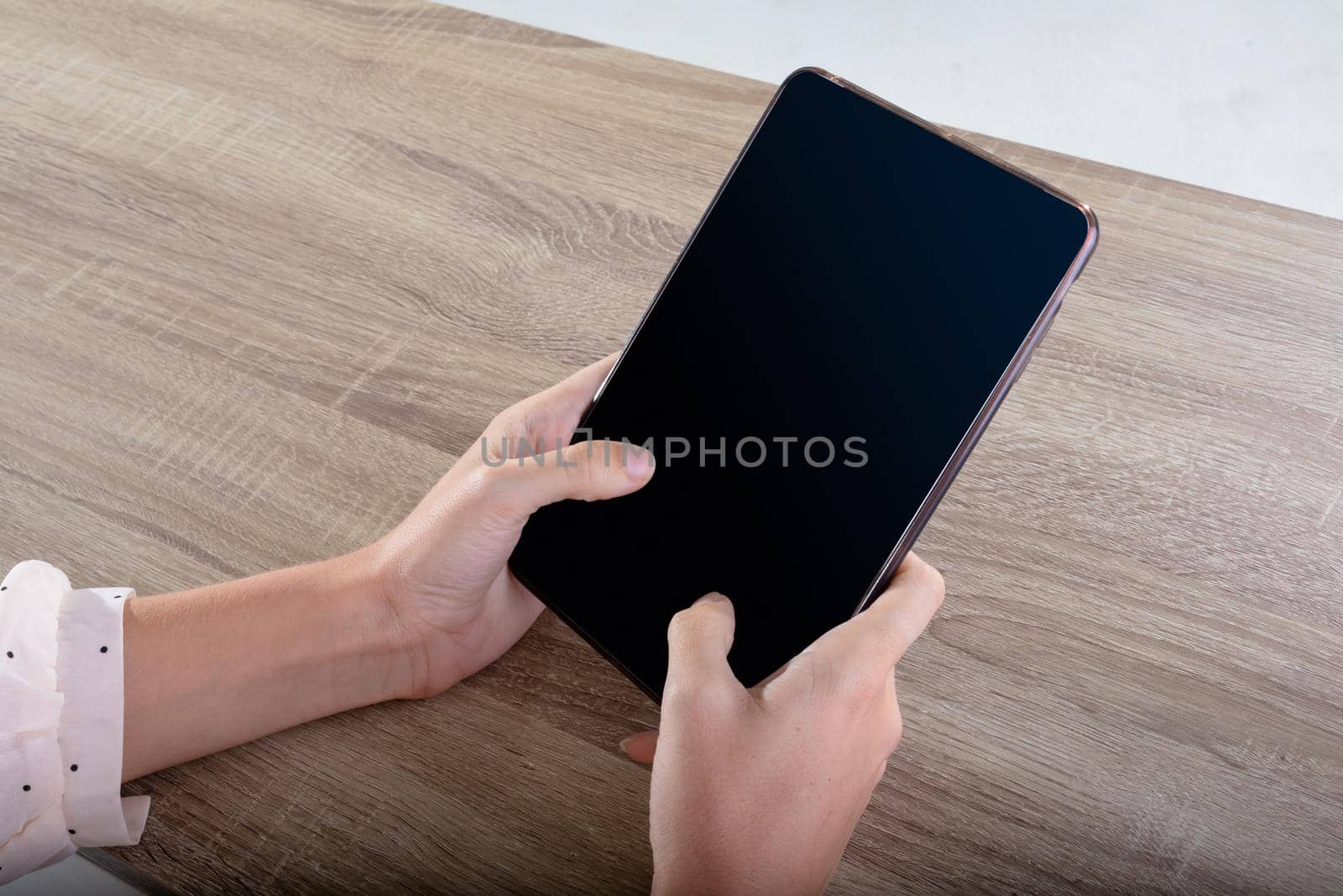 Midsection of caucasian businesswoman using tablet, isolated on grey background by Wavebreakmedia