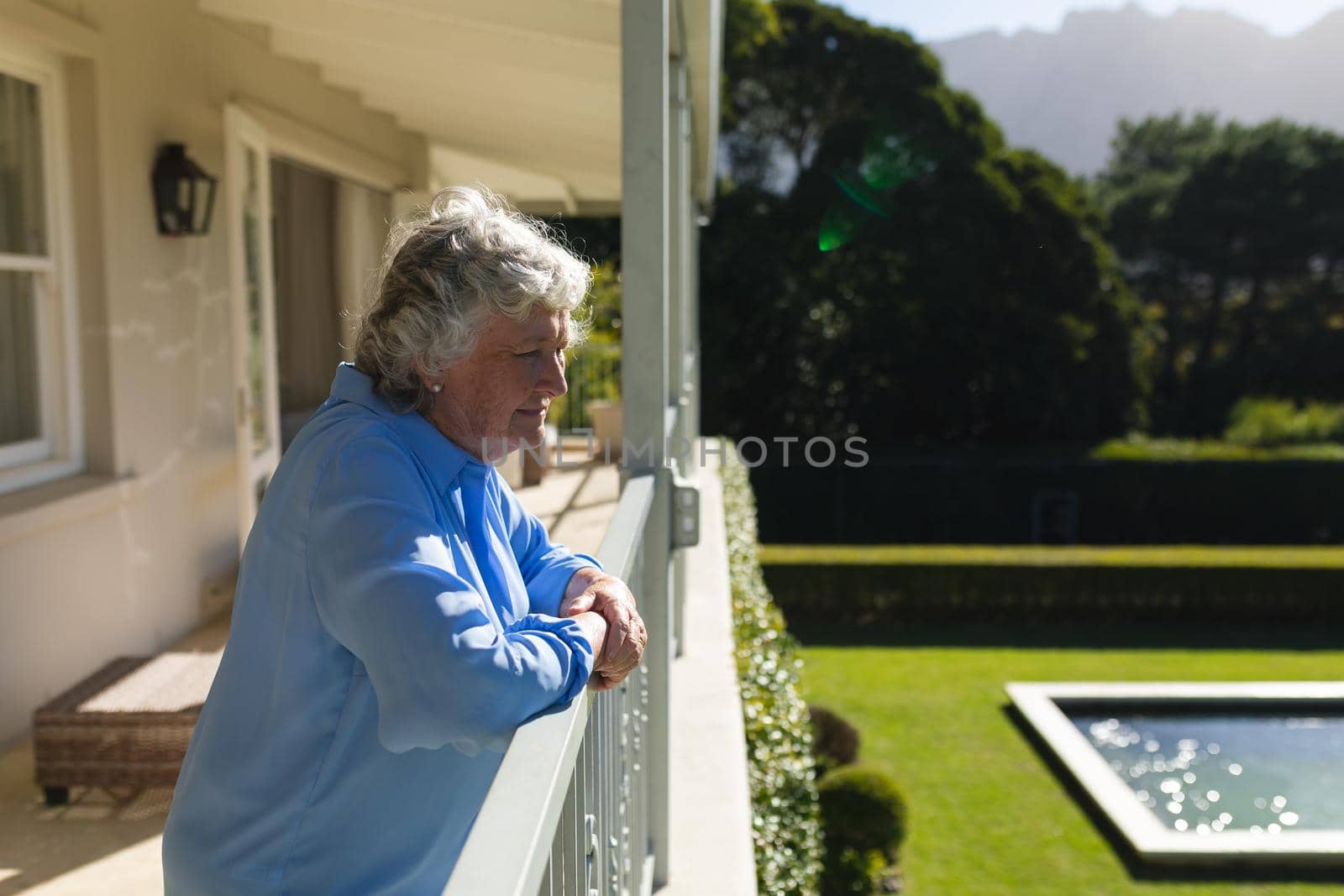 Senior caucasian woman standing on balcony and looking away by Wavebreakmedia