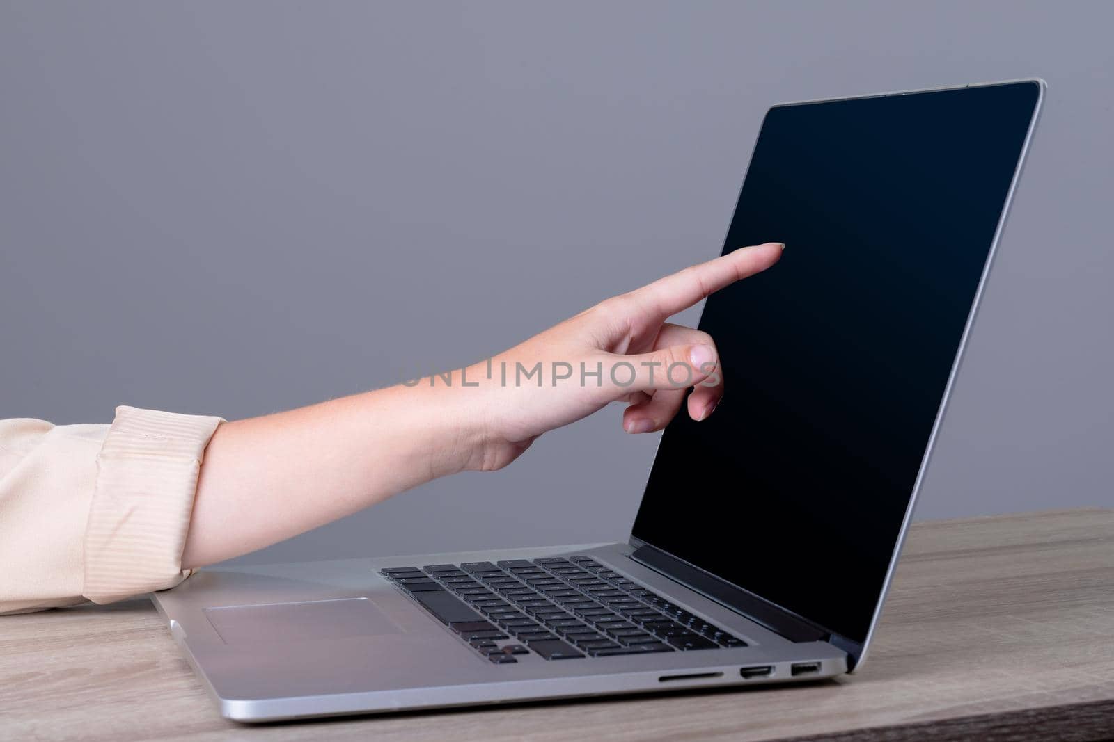 Midsection of caucasian businesswoman using laptop, isolated on grey background by Wavebreakmedia