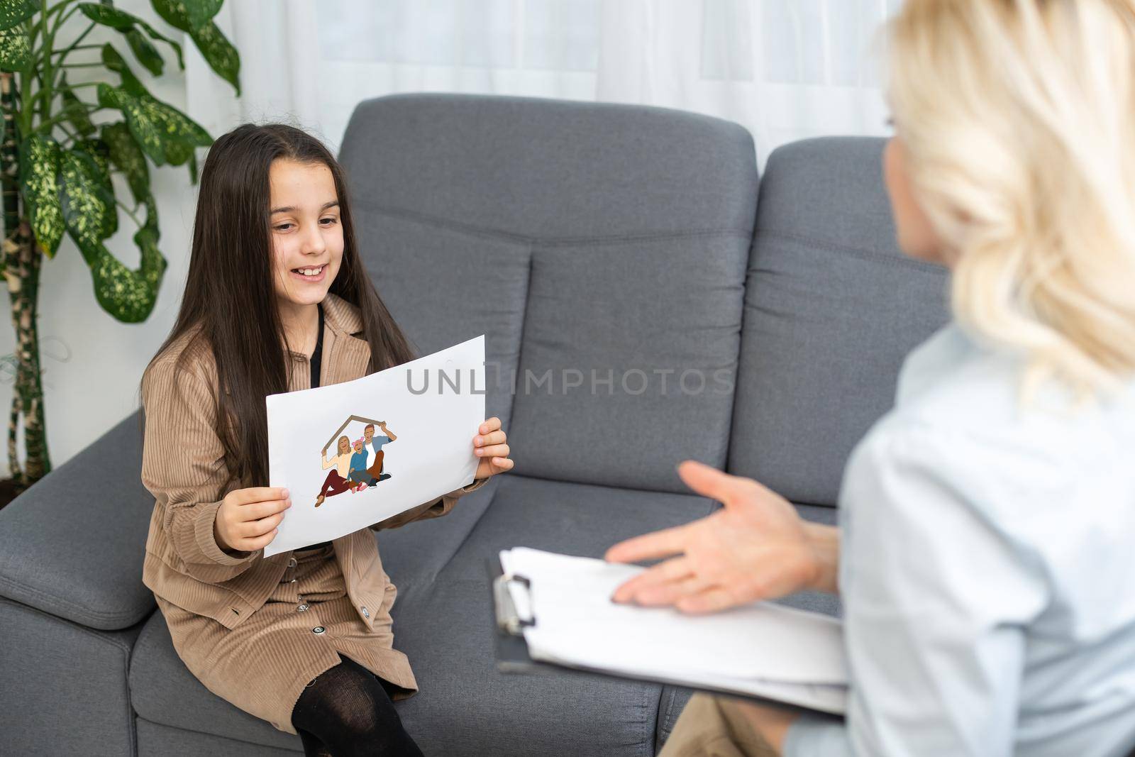 Communication session of school psychologist and girl 9, 10 years. Child tells psychotherapist his experiences, mental health of children