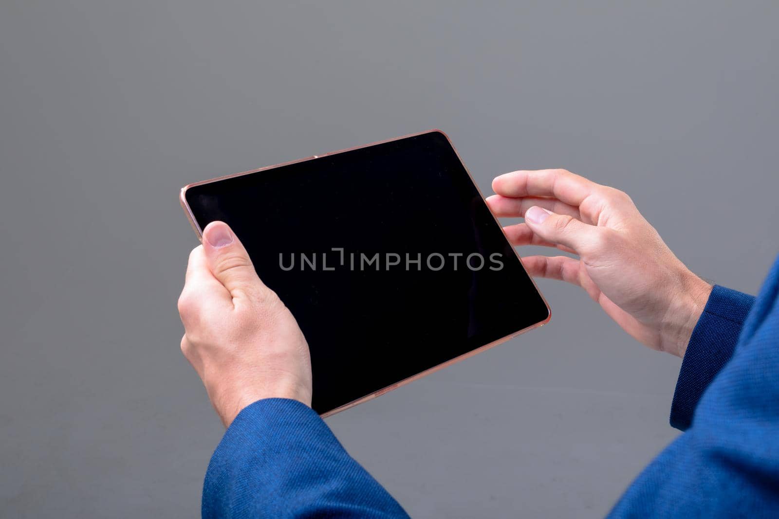 Midsection of caucasian businessman using tablet, isolated on grey background. business technology, communication and growth concept.