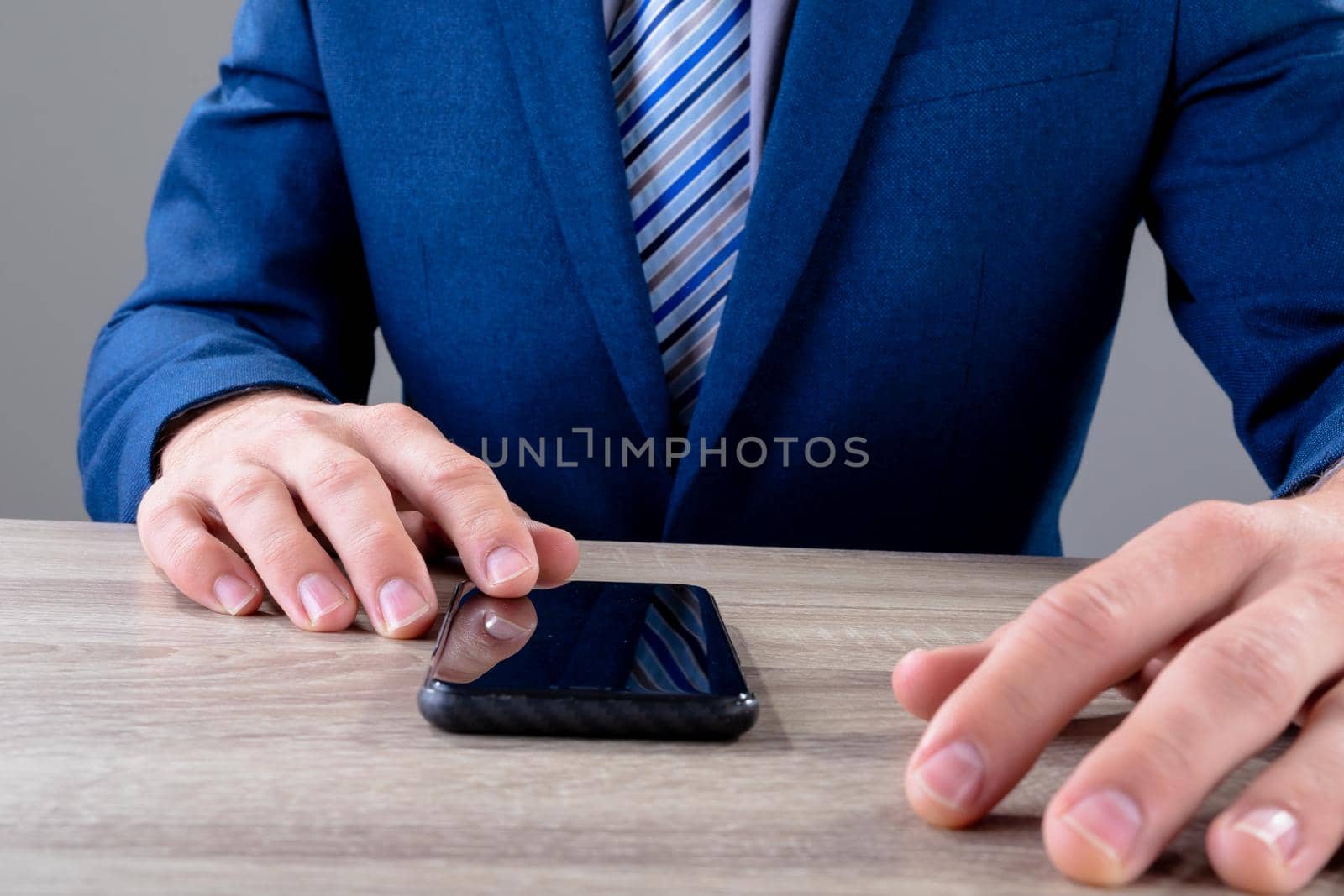 Midsection of caucasian businessman using smartphone, isolated on grey background. business technology, communication and growth concept digitally generated composite image.