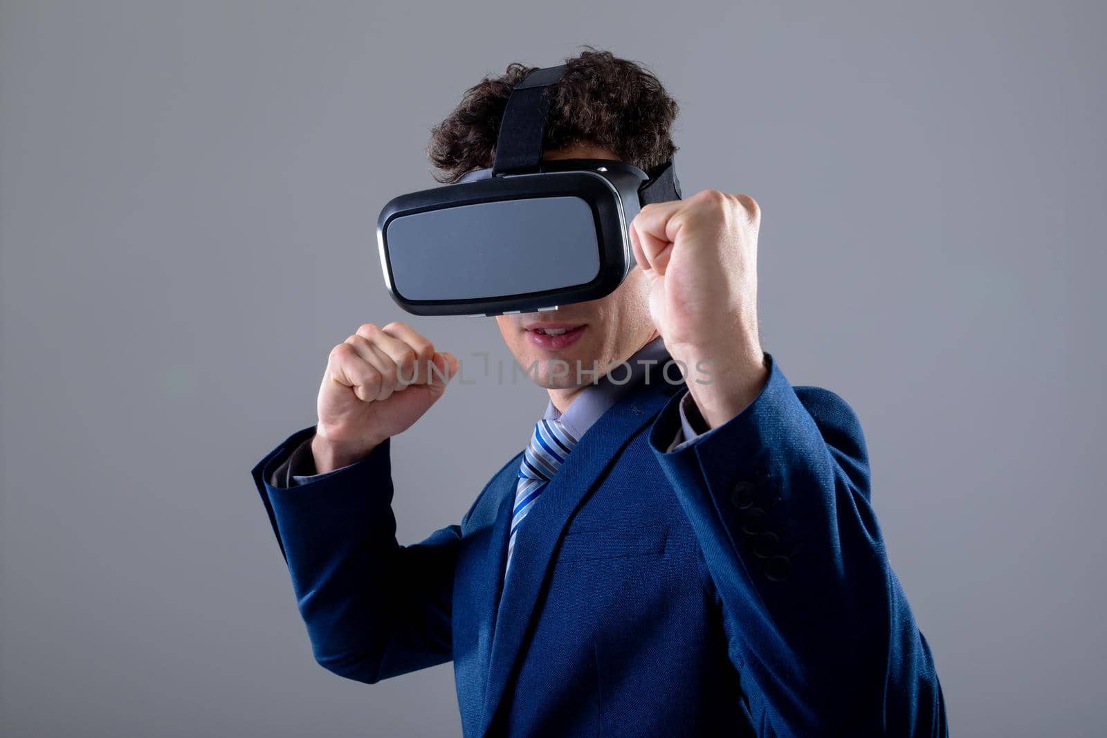 Caucasian businessman wearing vr headset, isolated on grey background. business technology, communication and growth concept digitally generated composite image.