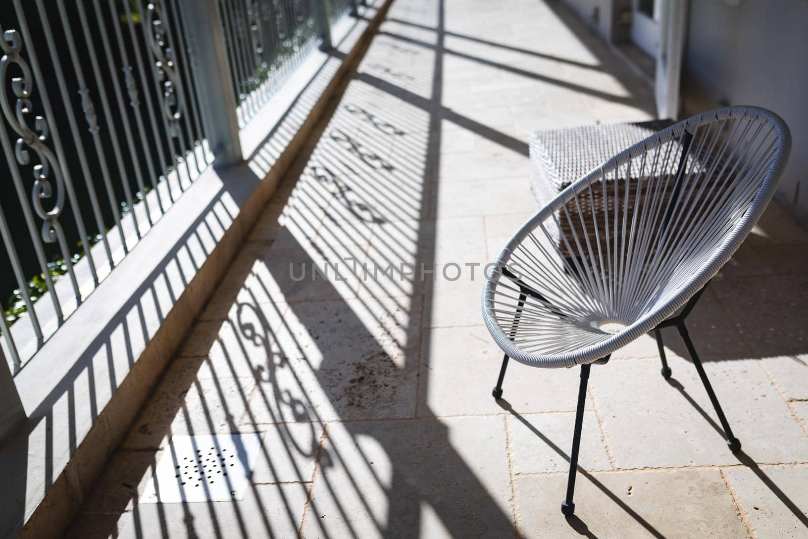 General view of round chair on a sunny balcony. interior design and home decoration concept.