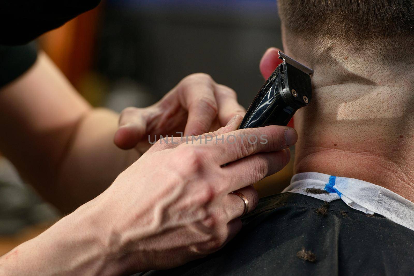 Close up of hair clipper. Person getting a haircut.