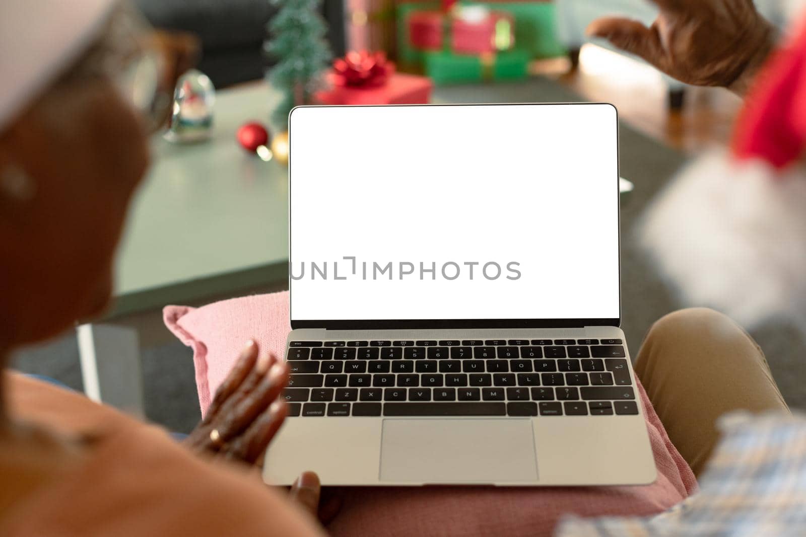 Back view of african american couple using laptop with copy space at christmas time by Wavebreakmedia