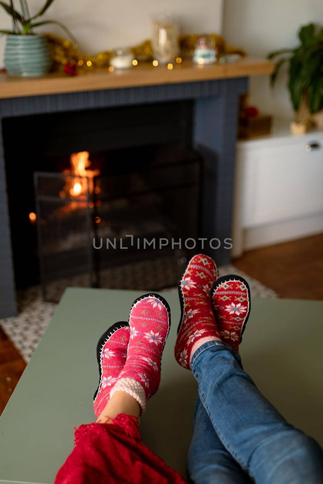 Feet of caucasian couple wearing christmas socks at christmas time by Wavebreakmedia