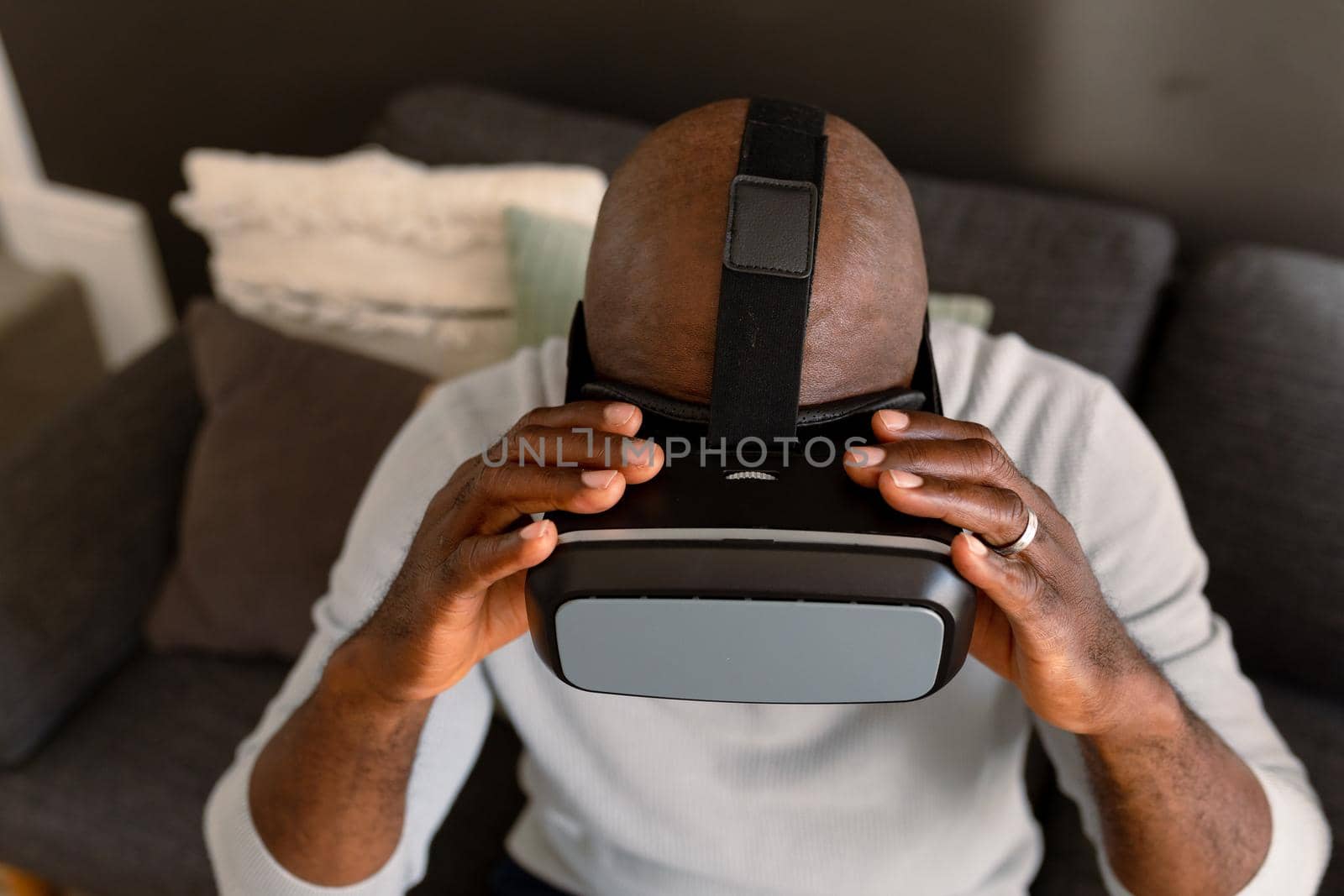 African american senior man wearing vr headset and having fun at home by Wavebreakmedia