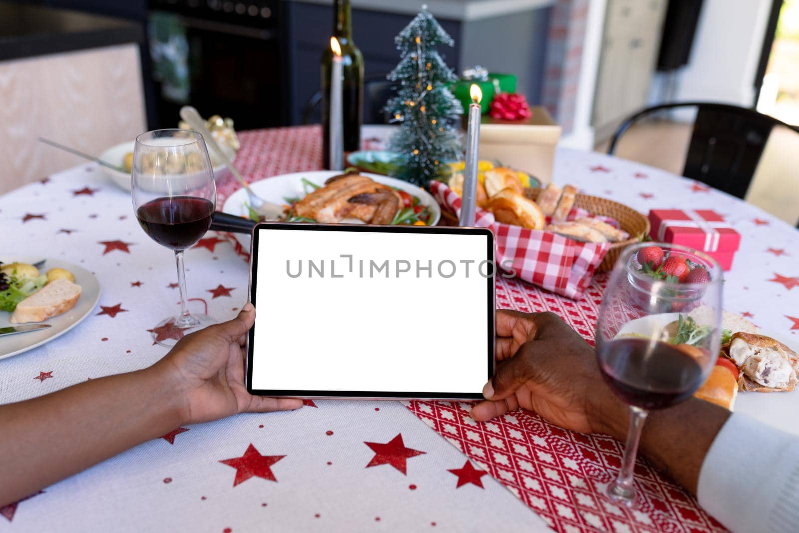 Hands of african american senior couple using tablet with copy space at christmas time by Wavebreakmedia