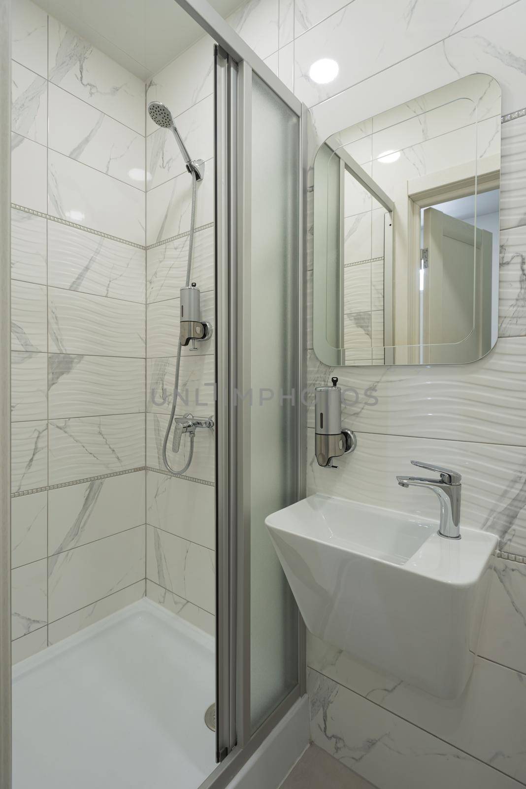 Interior of bright and modern white bathroom. shower cabin.