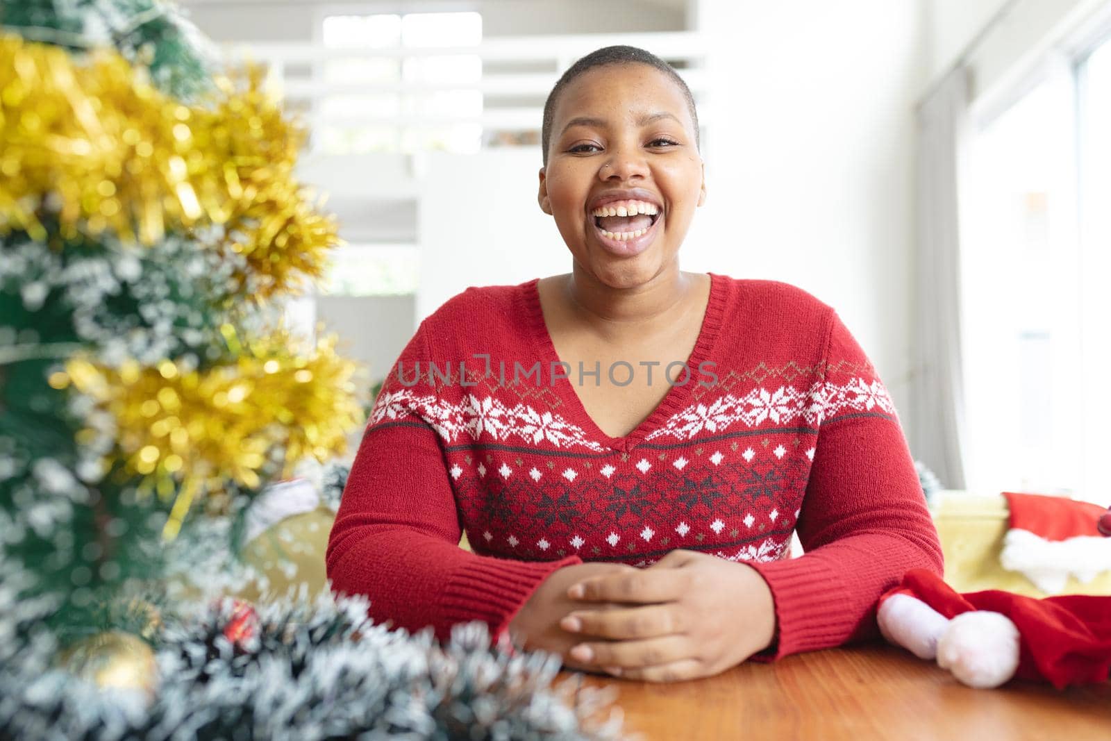 Happy african american plus size woman making christmas video call on laptop. christmas, festivity and communication technology.