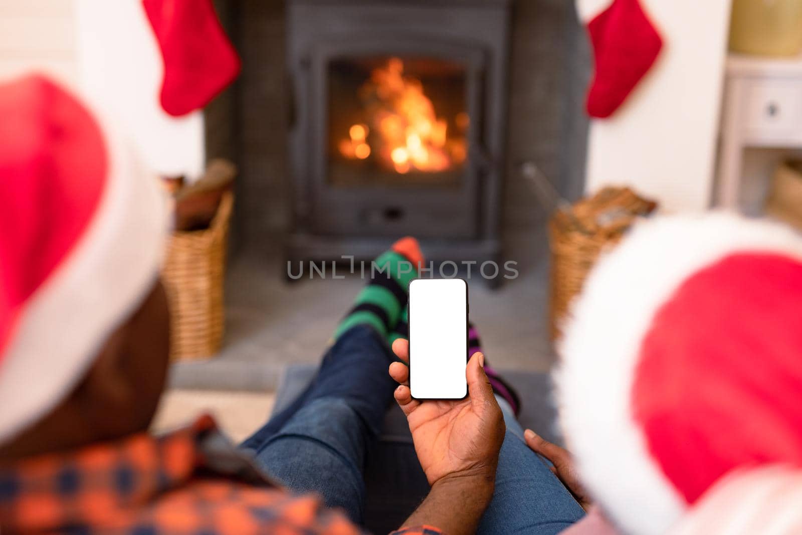 Back view of african american senior couple using smartphone with copy space at christmas time by Wavebreakmedia