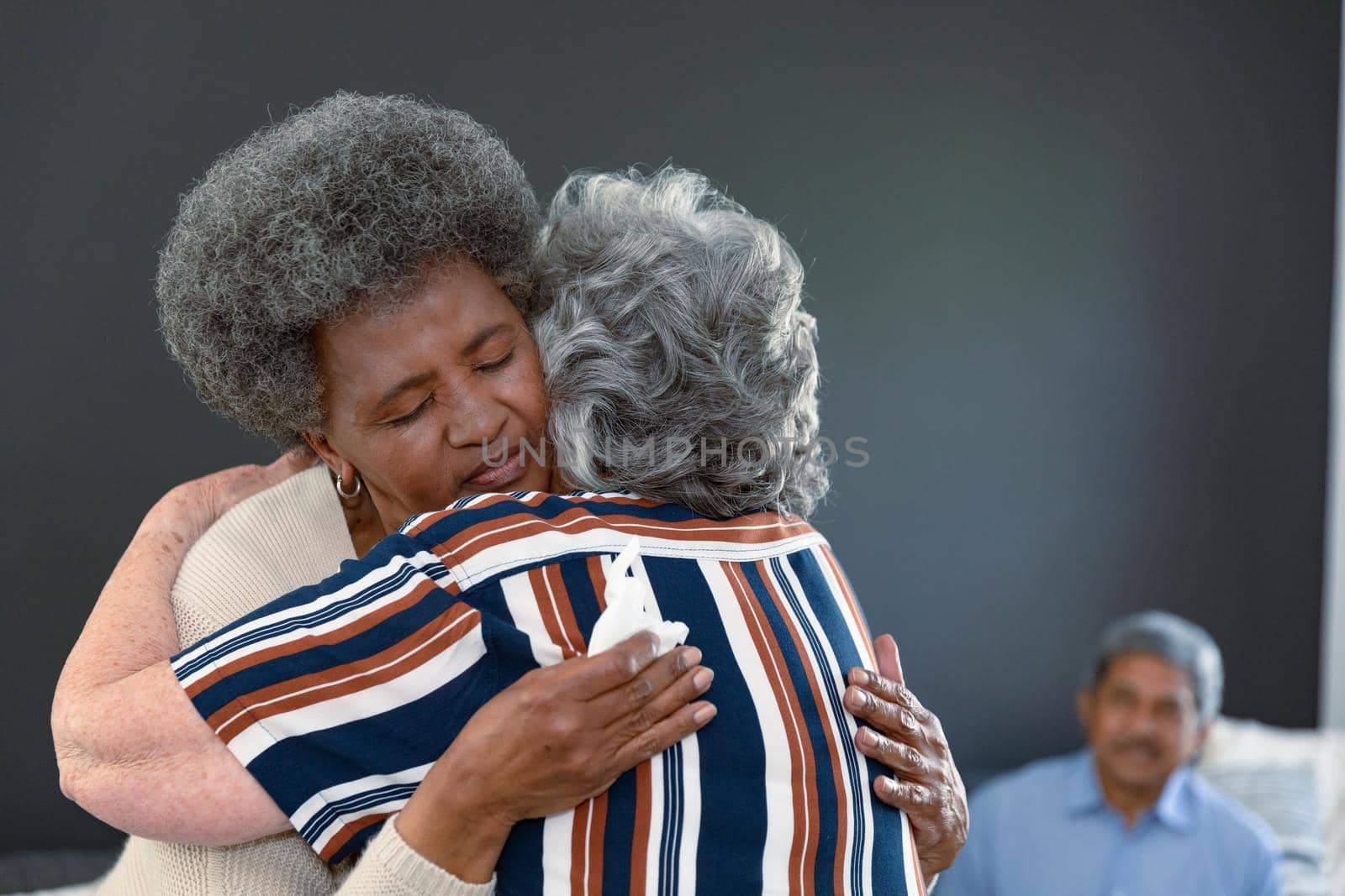 Caucasian senior woman embracing african american female friend and supporting her by Wavebreakmedia