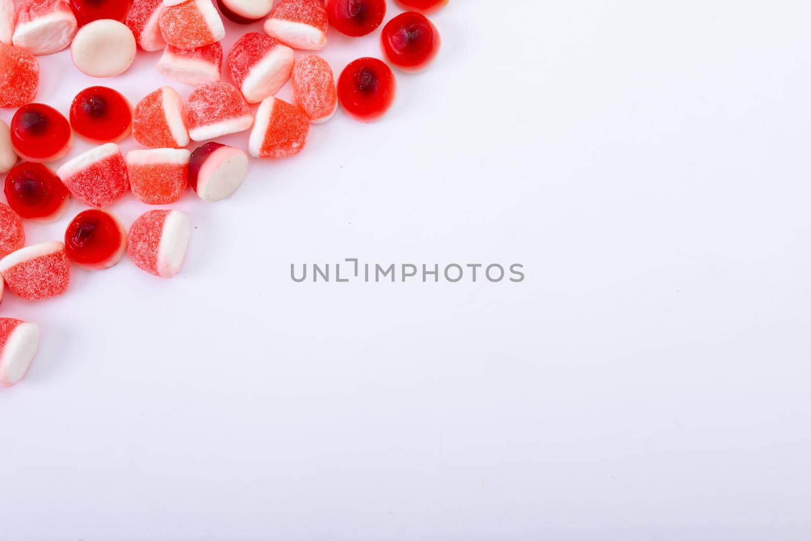 Composition of multiple halloween trick or treat sweets with copy space on white background. halloween tradition and celebration concept.