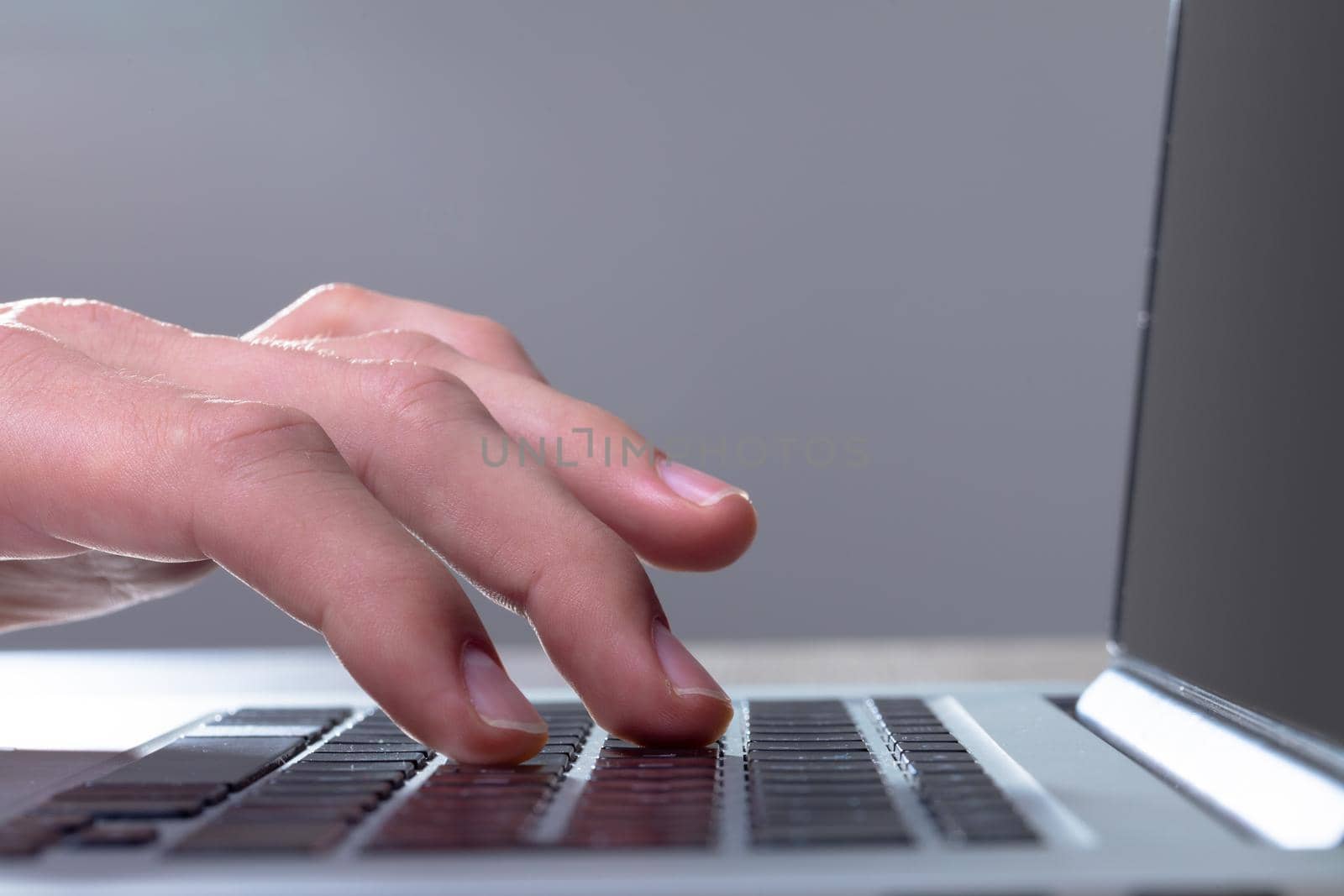 Close up of caucasian businessman typing on keyboard, isolated on grey background. business technology, communication and growth concept digitally generated composite image.