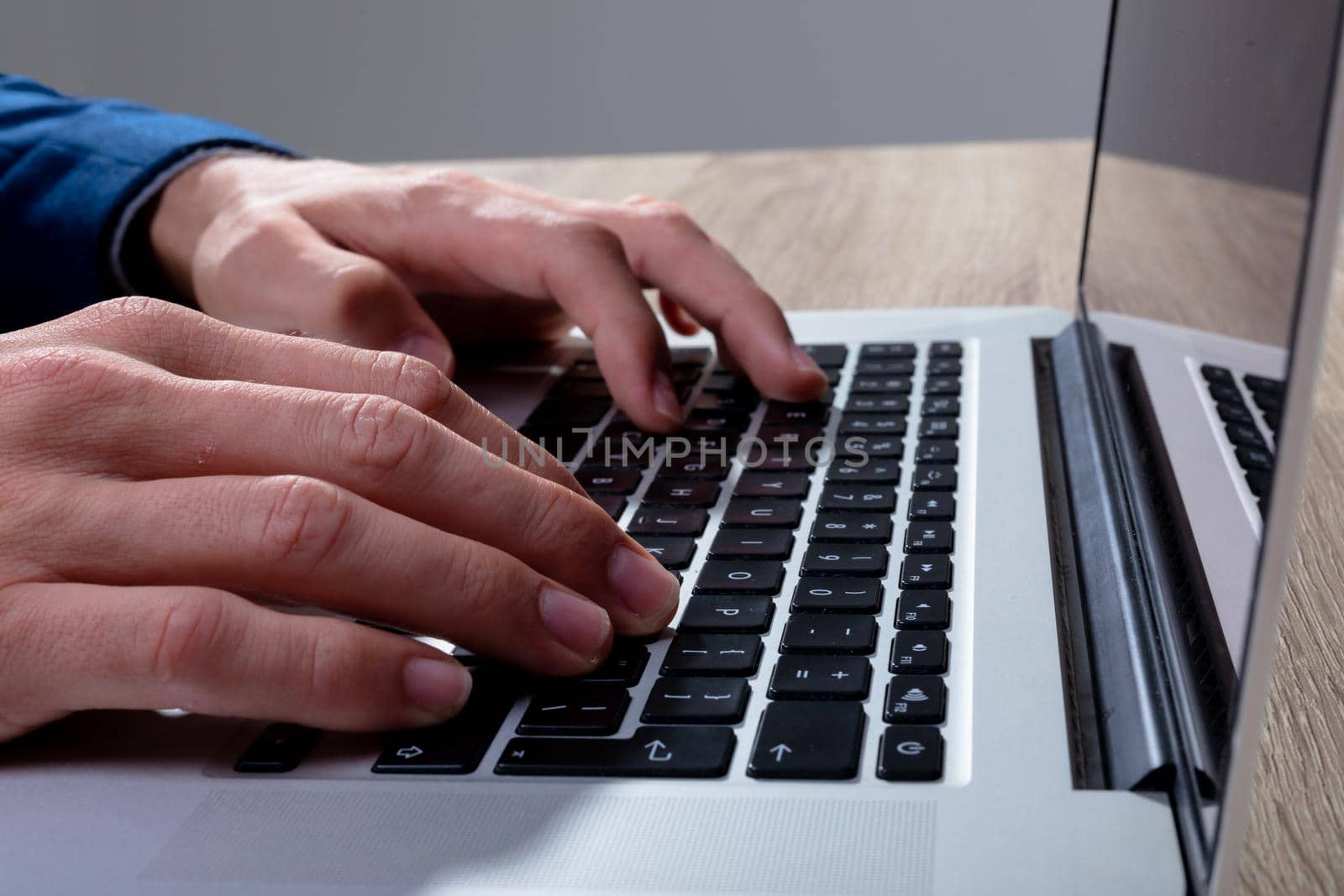 Midsection of caucasian businessman typing on keyboard, isolated on grey background. business technology, communication and growth concept digitally generated composite image.