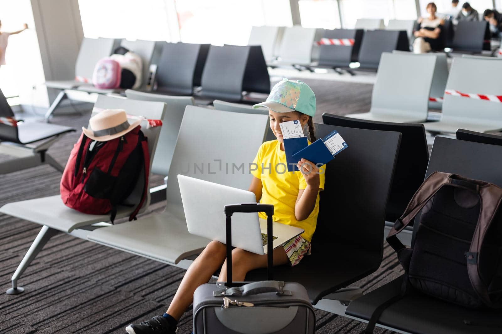 Adorable little girl in airport with her luggage and laptop by Andelov13