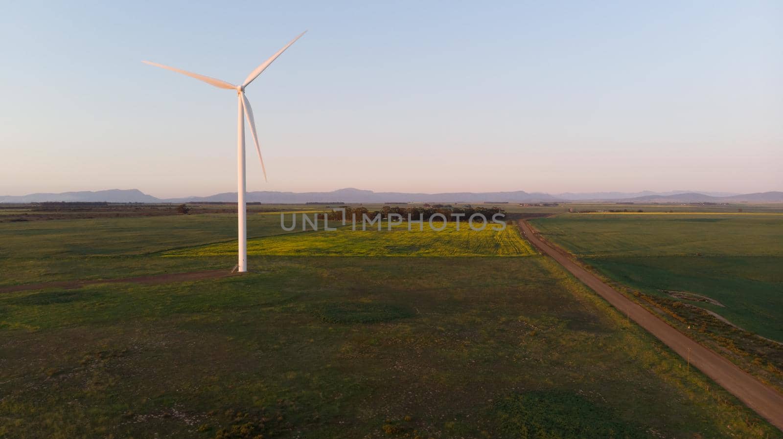 General view of wind turbine in countryside landscape with cloudless sky. environment, sustainability, ecology, renewable energy, global warming and climate change awareness.