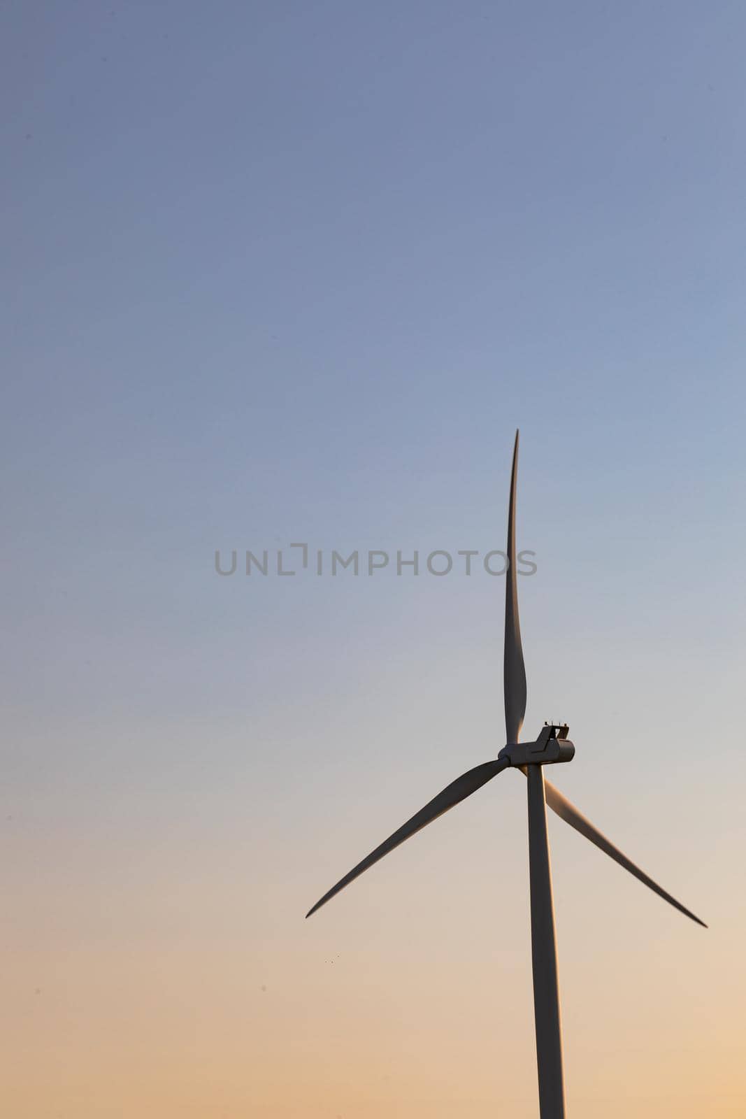 Close up of wind turbine in countryside landscape with cloudless sky by Wavebreakmedia