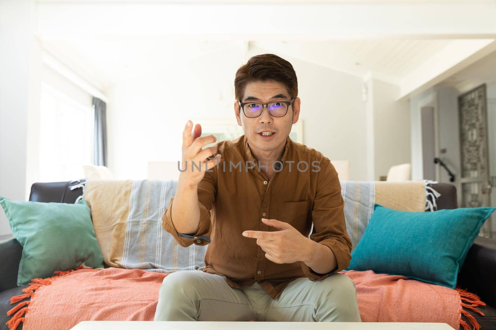 Asian man during video call at home. domestic lifestyle and working online during covid 19 pandemic concept.