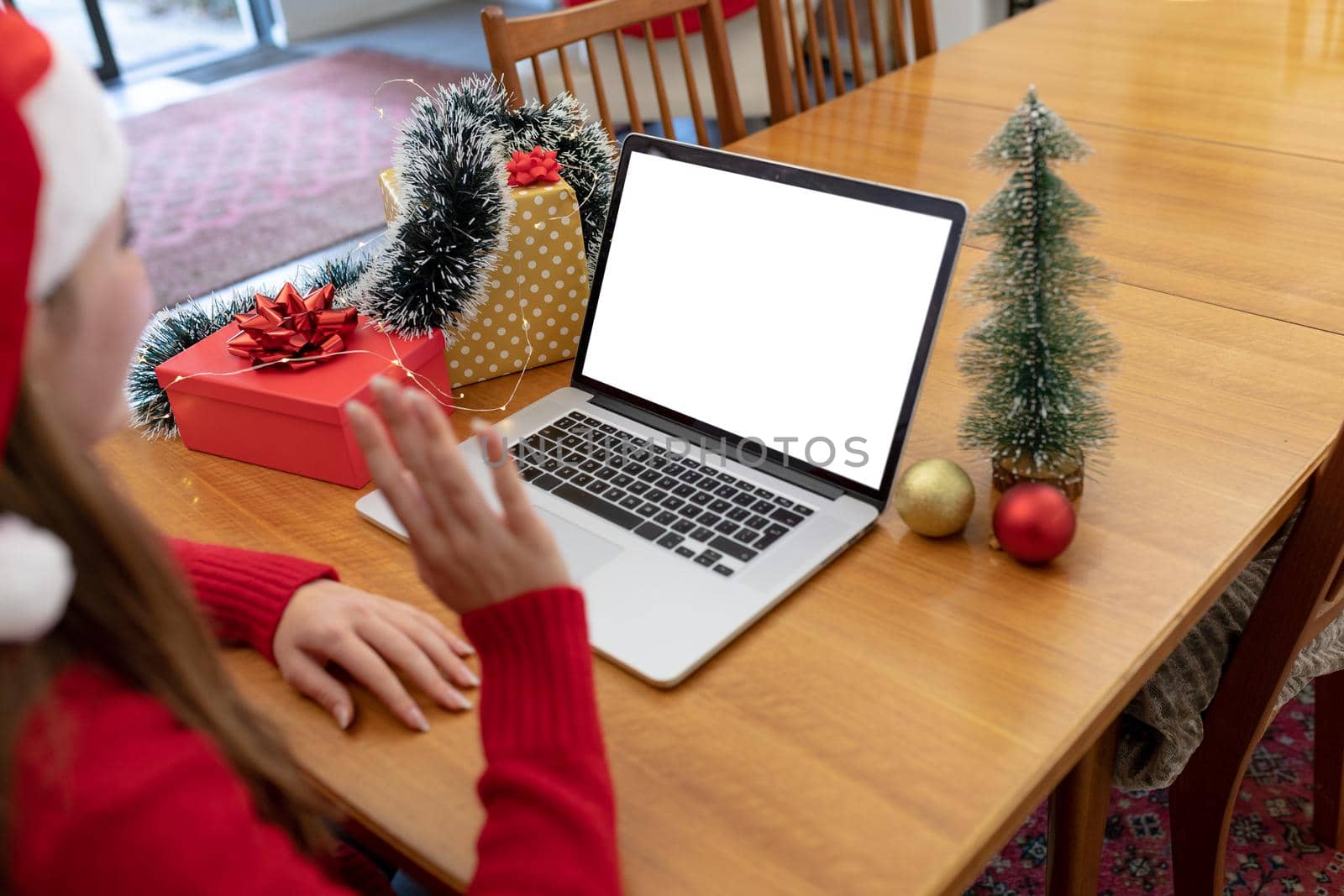 Caucasian woman wearing santa hat having video call on laptop with copy space at christmas time by Wavebreakmedia