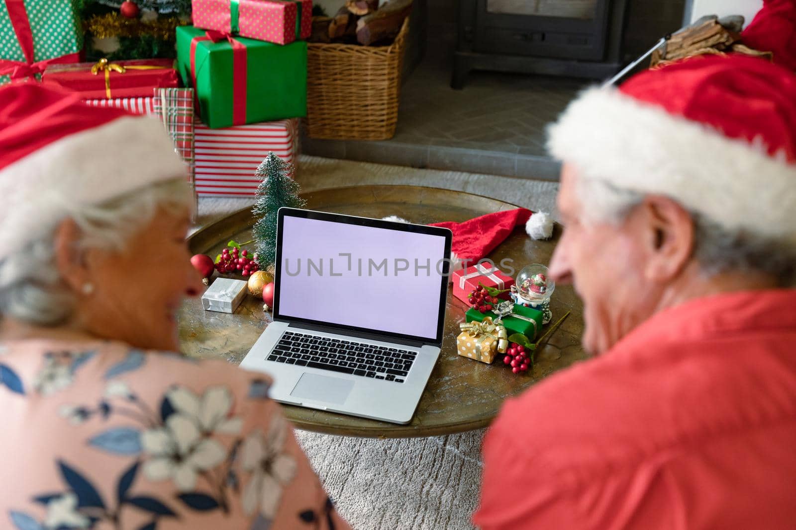 Caucasian senior couple wearing santa hats using laptop with copy space at christmas time by Wavebreakmedia