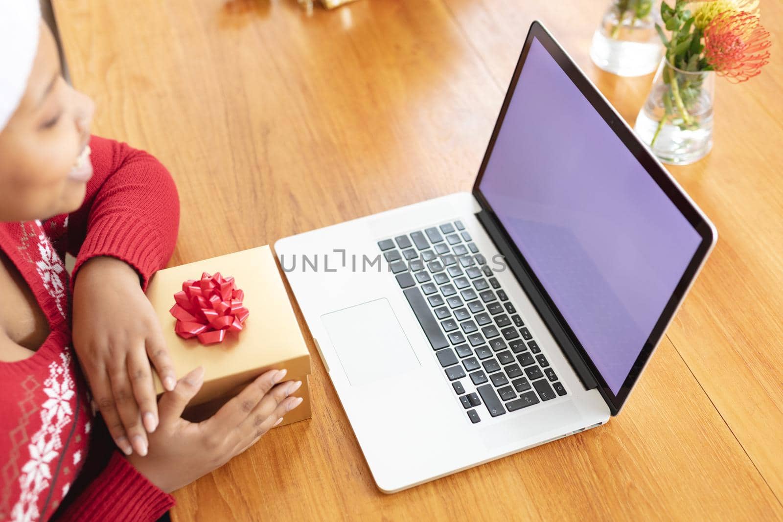 Happy african american plus size woman making christmas video call on laptop with copy space. christmas, festivity and communication technology.