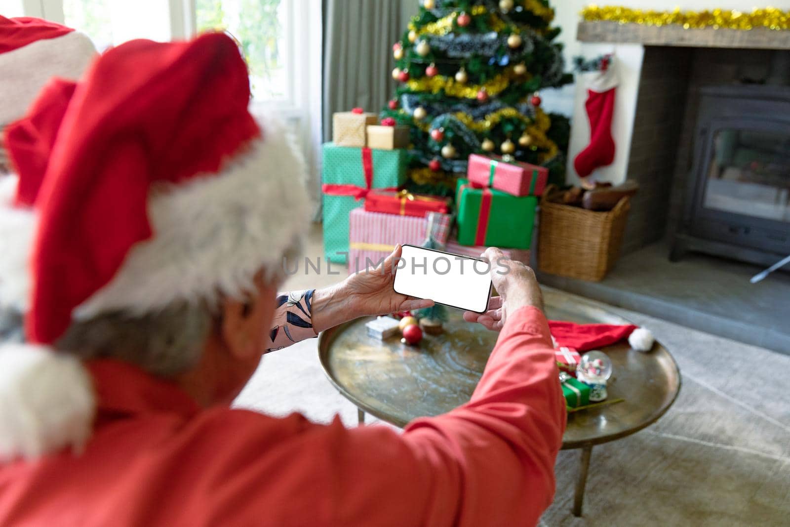 Caucasian senior couple wearing santa hats using smartphone with copy space at christmas time by Wavebreakmedia