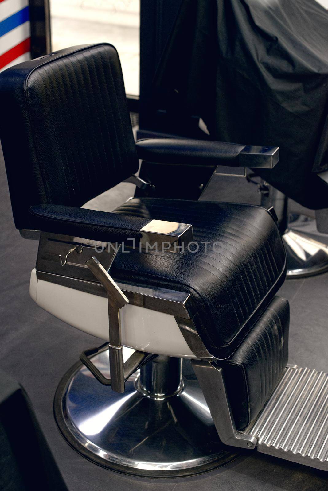 Black eather retro armchair for hairdresser barbershop.